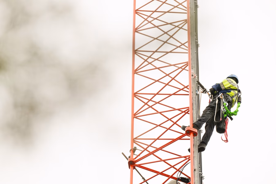 A person climbing a mobile mast