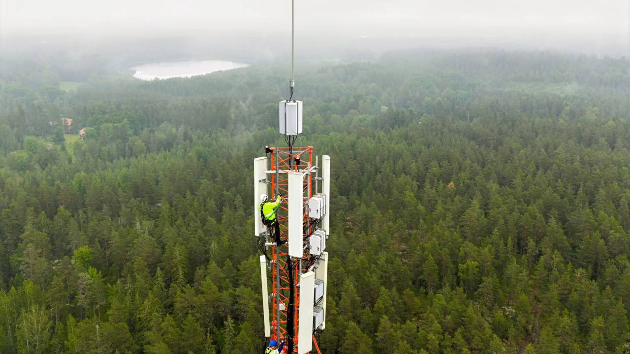 two people climbing a mobile mast